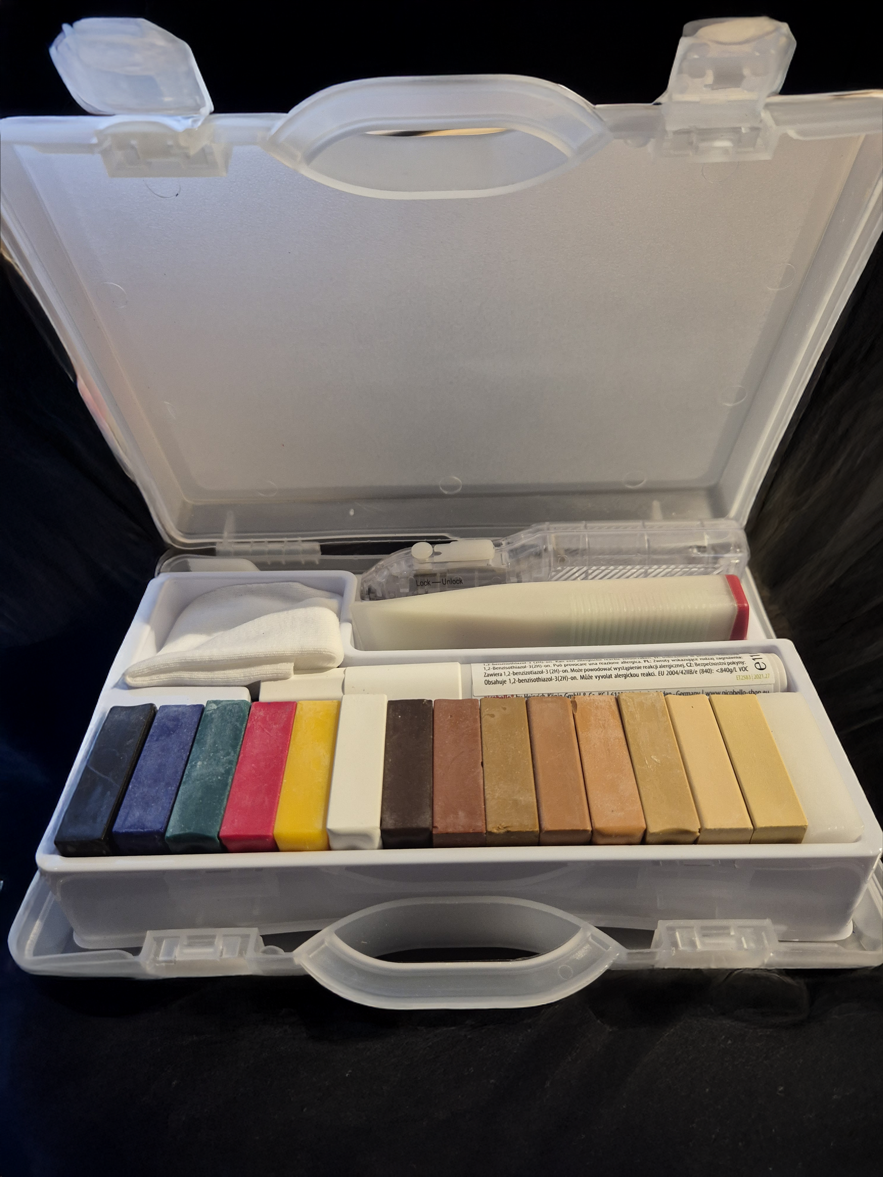 Premium Wood Repair Kit open in its clear case, with coloured hard wax sticks, a battery melter, a cloth and a lacquer pen