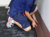 AcoustaMat acoustic underlay being installed under timber flooring