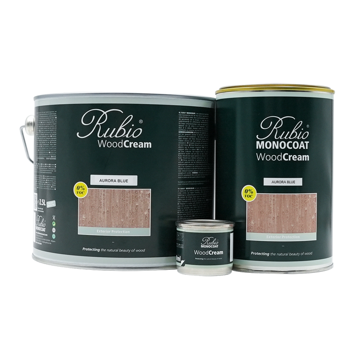 Three cans of Rubio WoodCream wood finish on a white background