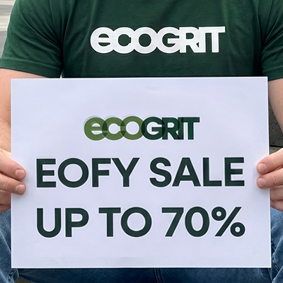 Person wearing an 'ecogrit' t-shirt holding a sign with EOFY sale information.